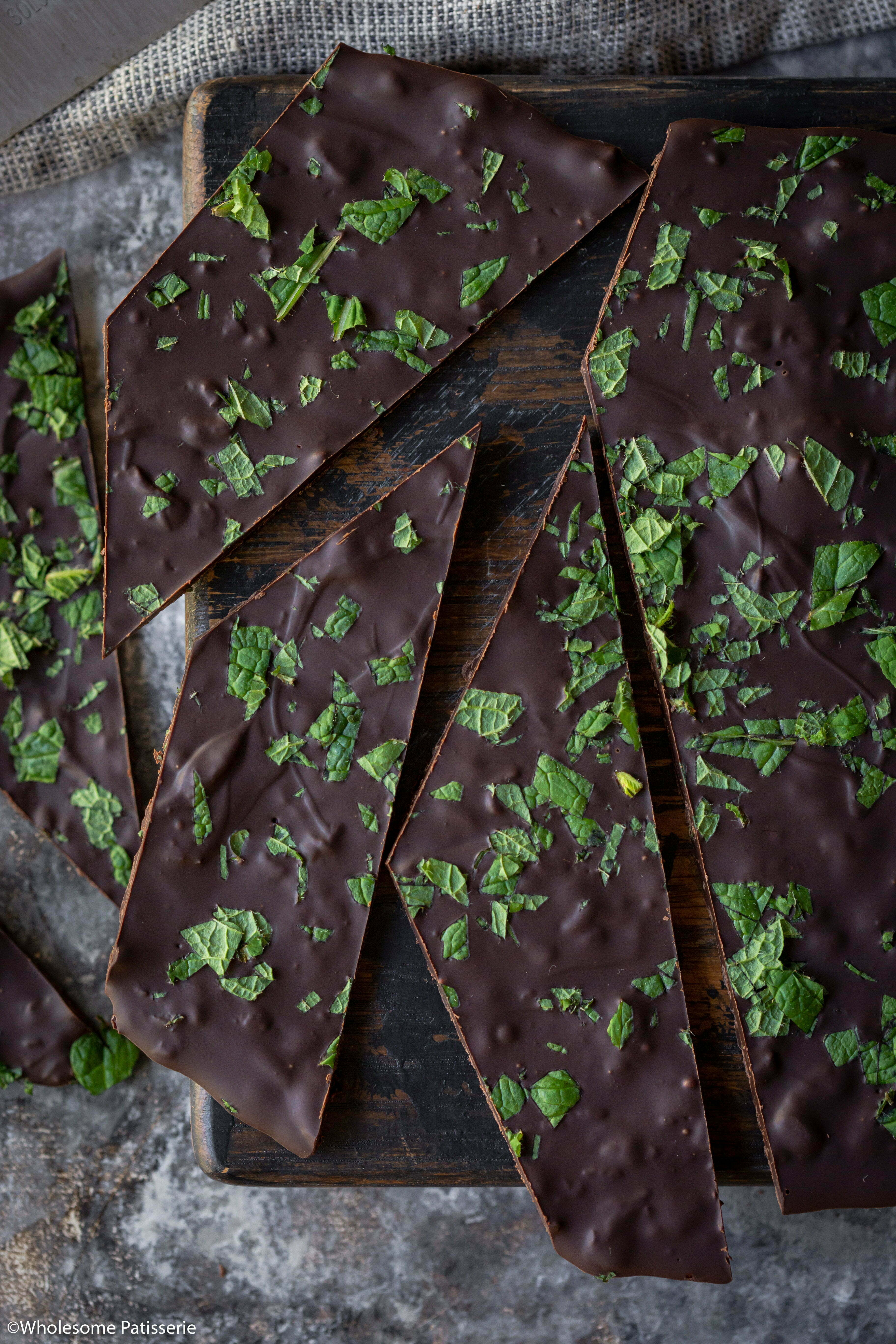 Close up image of the mint chocolate bark showing the fresh mint leaves and texture. 