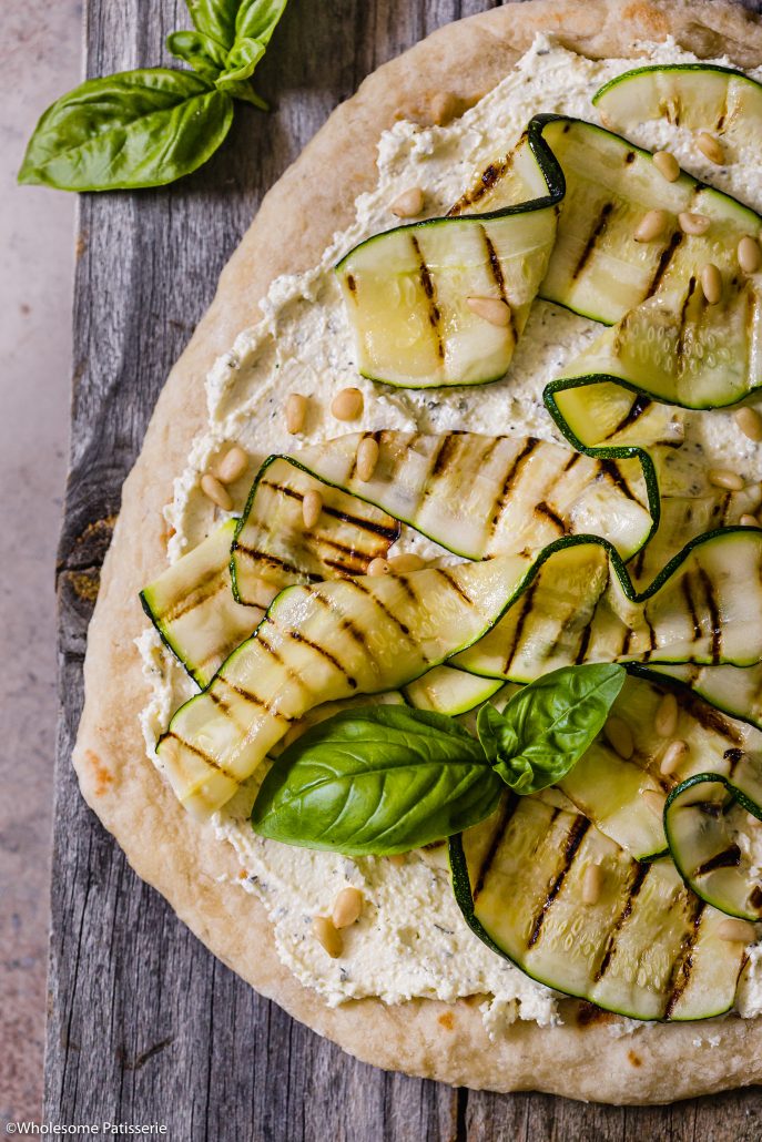 Grilled Zucchini & Whipped Feta Flat Bread! Homemade 3-ingredient flat bread topped with creamy oil and herb infused whipped feta, grilled zucchini, pine nuts & fresh basil! 