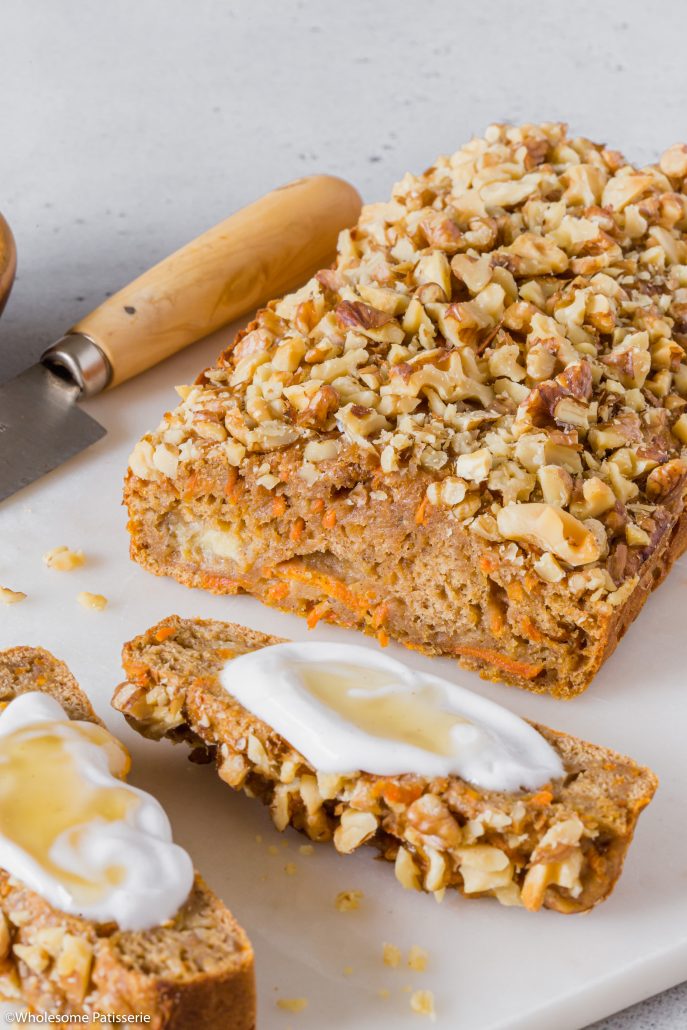 Banana & Carrot Snack Loaf! This simple and quick loaf is a beautiful blend of banana bread and carrot cake. It’s smaller in height than traditional large loaves which makes it perfect for snacking.   It features ripe bananas, grated carrot, cinnamon, nutmeg and walnuts. The texture is not as soft as a cake, it’s definitely heavier, just like a banana or carrot bread loaf. It’s moist and flavourful. Sweetened with honey and coconut sugar which offers another layer of interest. 