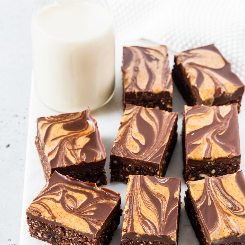 No-Bake Almond & Chia Chocolate Brownies! Rich, decadent and healthier for you brownies! These are no-bake brownies topped with a luscious melted dark chocolate brownies with an almond butter swirl. Enjoy with your morning cup of tea or after dinner snack.