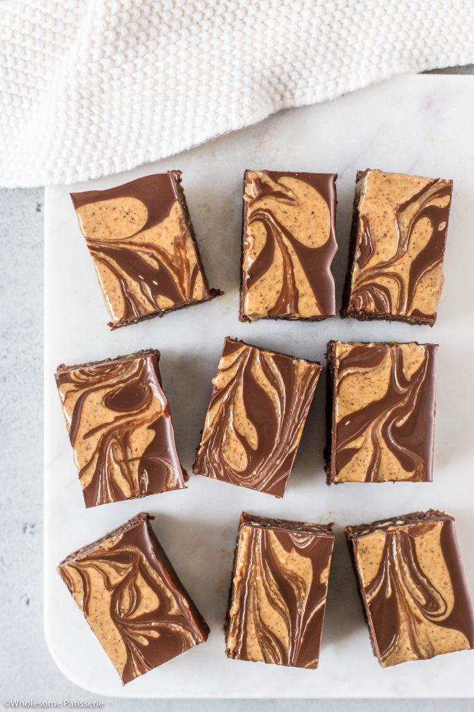 No-Bake Almond & Chia Chocolate Brownies! Rich, decadent and healthier for you brownies! These are no-bake brownies topped with a luscious melted dark chocolate brownies with an almond butter swirl. Enjoy with your morning cup of tea or after dinner snack. 