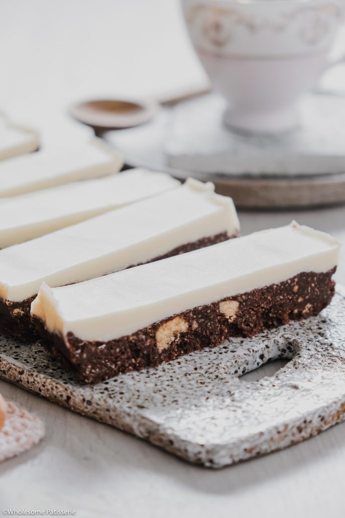 White Chocolate Thin Mint Slice! This delightful slice is no-bake and infused with peppermint essential oil in both the base and topping. The chocolate base is a simple 5-ingredient biscuit mixture using Dutch cocoa powder and peppermint oil. The topping is only 2-ingredients, white chocolate and more peppermint!