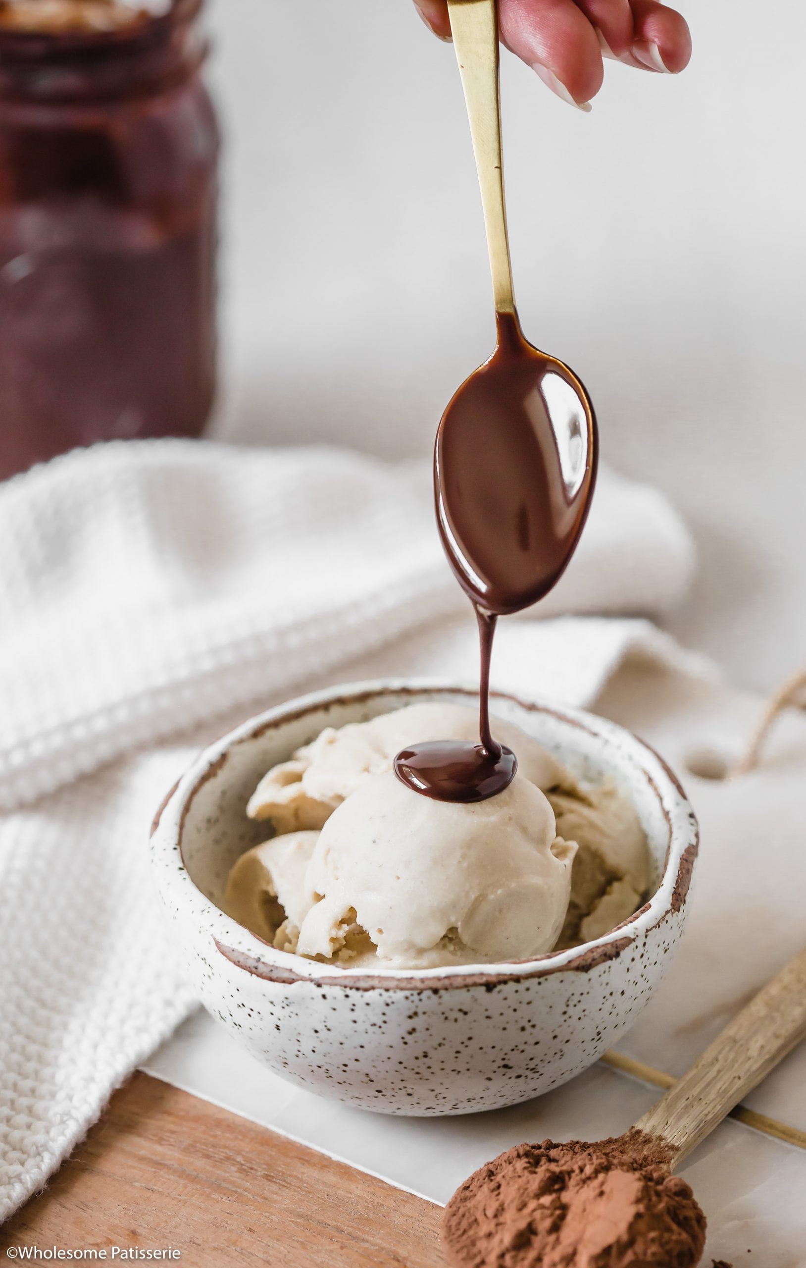 Pouring the homemade chocolate sauce over ice cream.