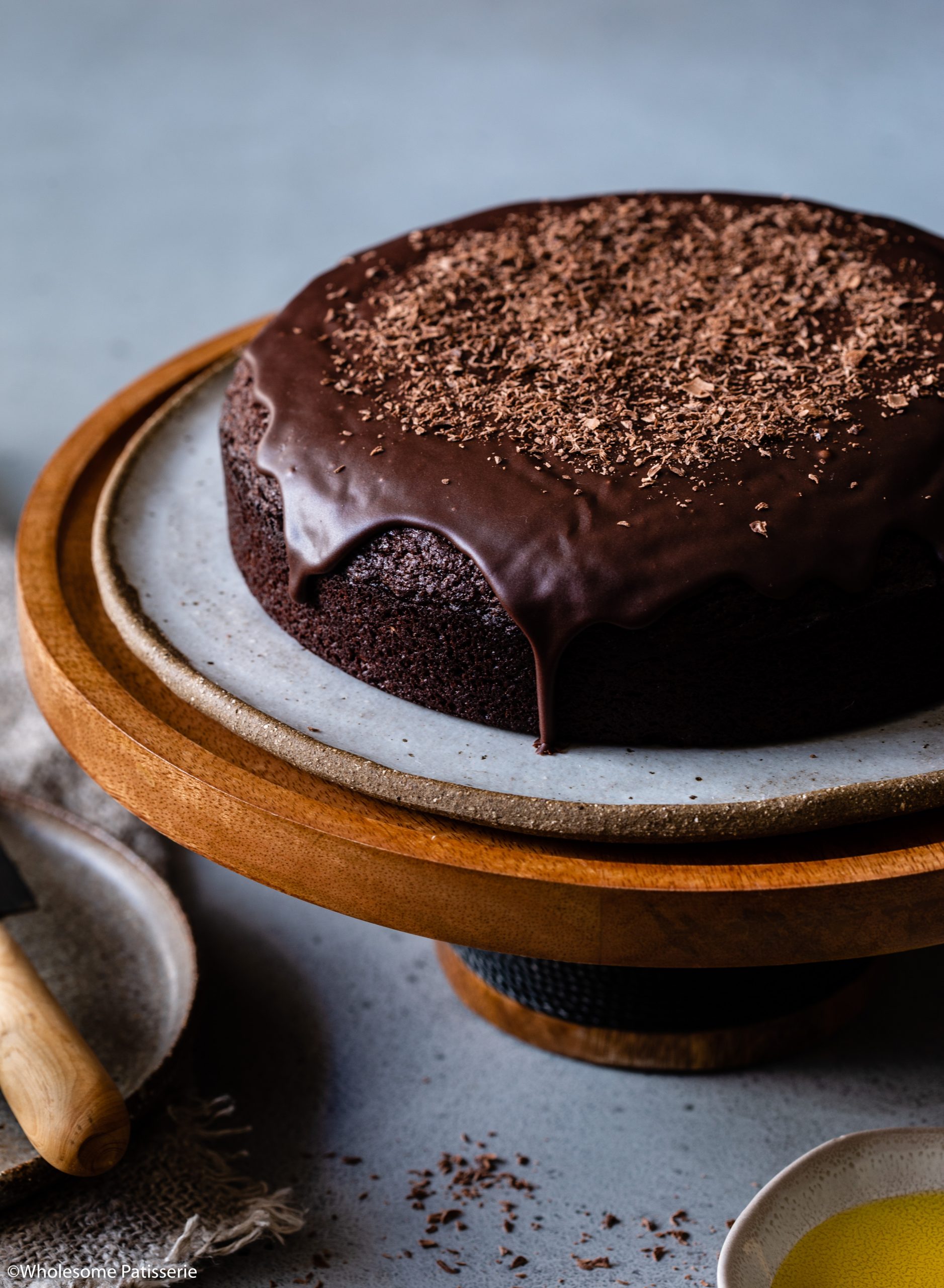 Easy chocolate fudge cake on wooden cake stand 