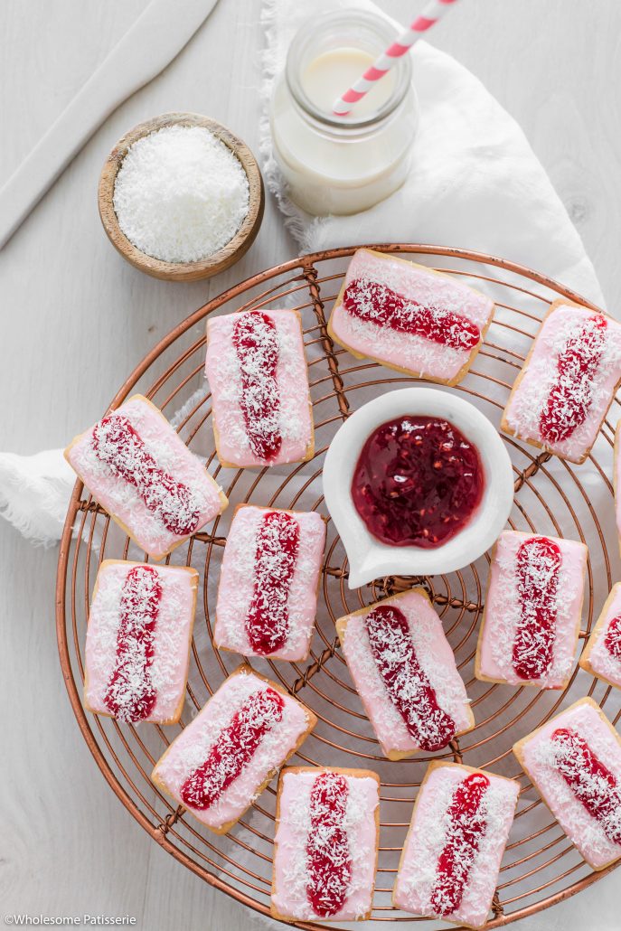 Iced Vovo Biscuits! Delicious biscuits topped with a marshmallow icing, a spread of raspberry jam and a sprinkle of desiccated coconut. These classic Australian biscuits will remind many of their childhoods. They’re oh so sweet and a wonderful treat to enjoy. 