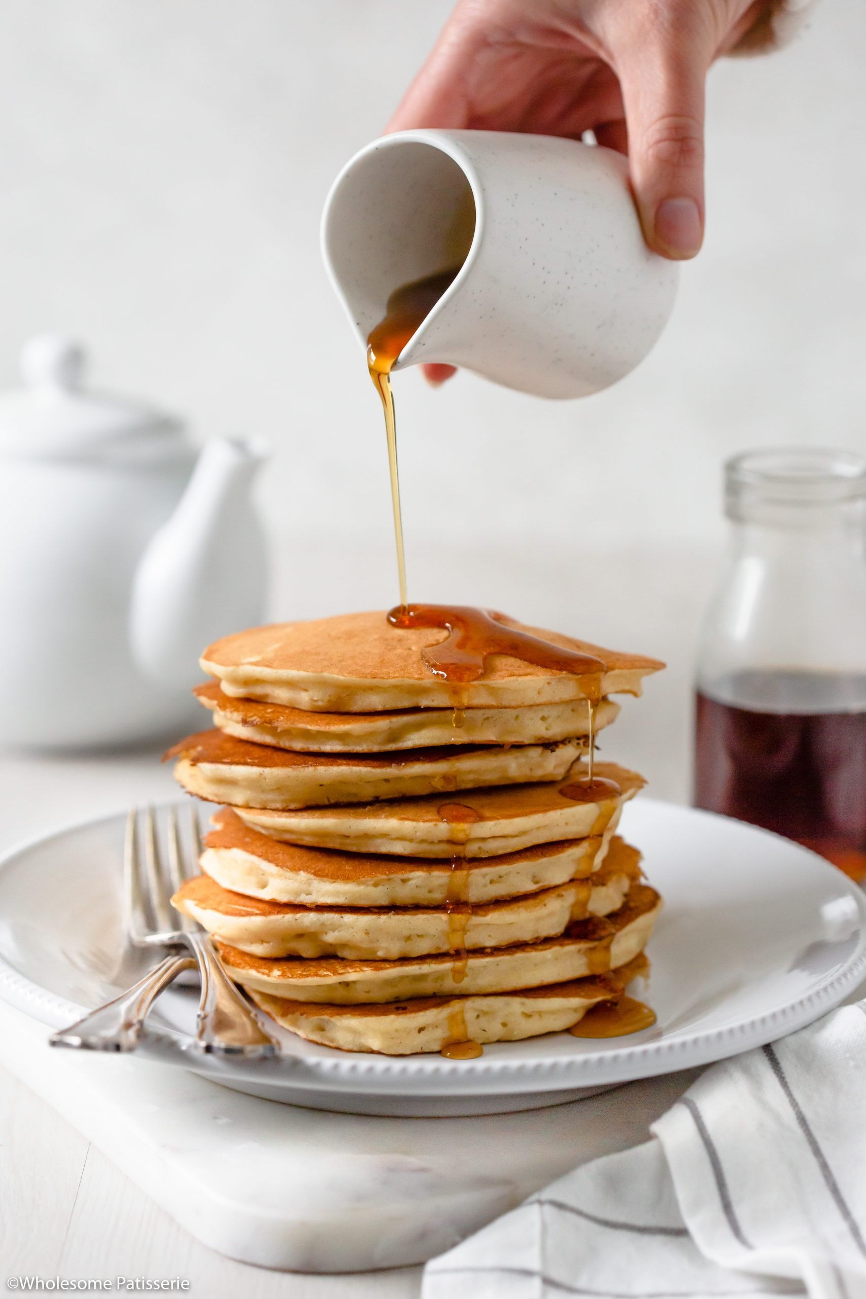 Drizzling maple syrup over the fluffy best pancakes