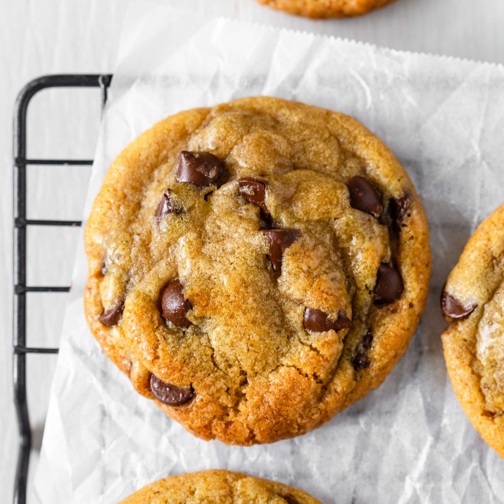 The Best Chewy Chocolate Chip Cookies! These are your ultimate bakery style, chewy and soft chocolate chip cookies. Melted butter and brown sugar promise you a chewy and gooey cookie with golden edges that offer a slight crunch. These are created in one bowl with no mixer required. Dark chocolate chips throughout for that iconic chocolate chip cookie goodness.