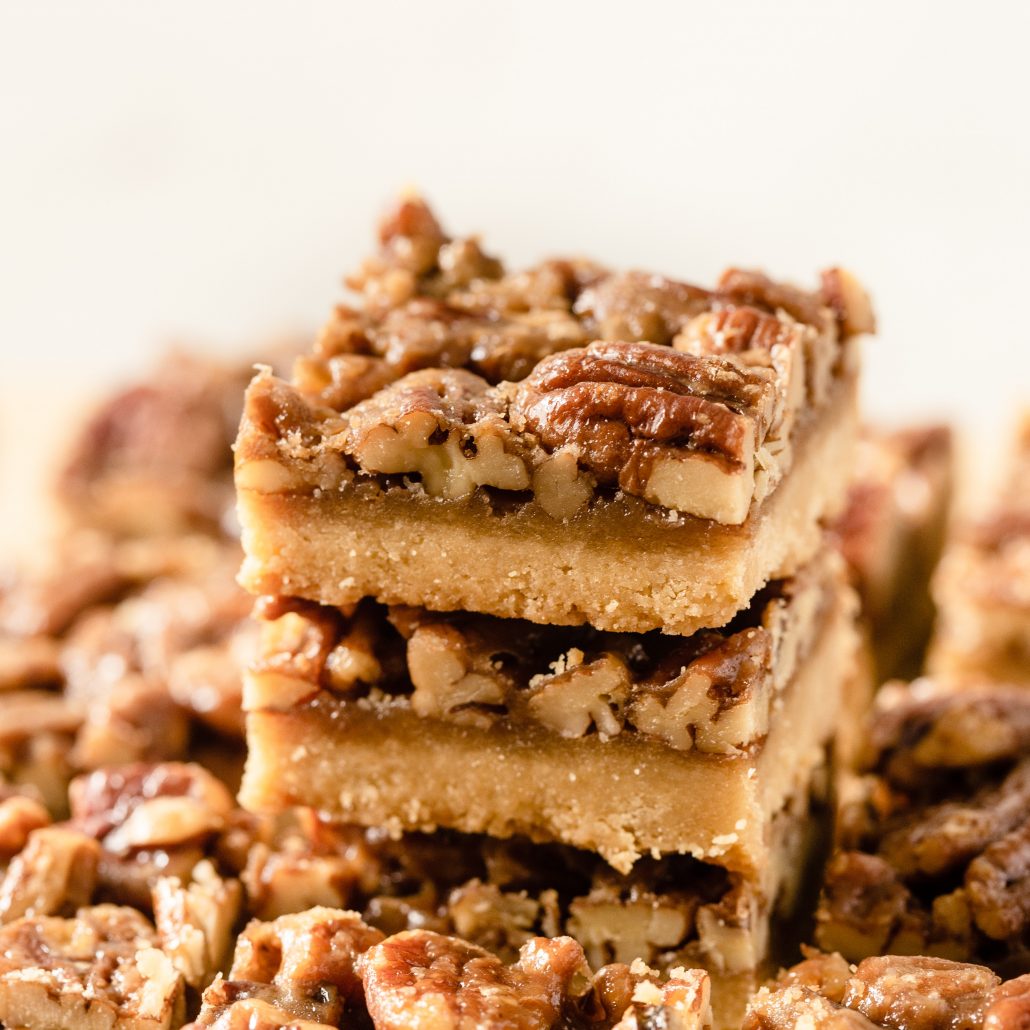 A scrumptious batch of Pecan Pie Bars will satisfy everyones sweet tooth. Created with an easy 4-ingredient shortbread base and an indulgent brown sugar and maple caramel pecan topping. These bars are a take on the traditional pecan pie, a classic and popular American dessert.
