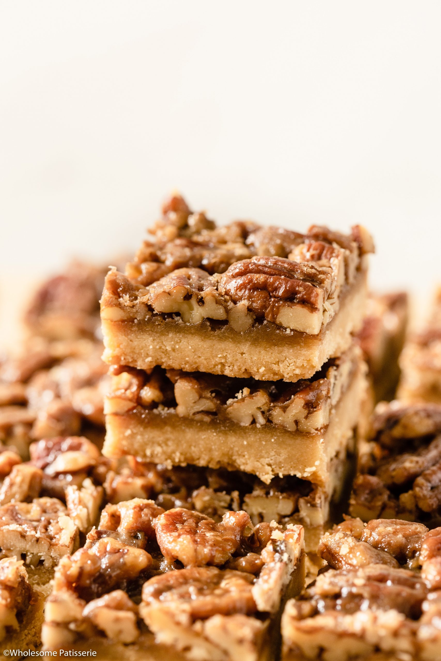 A scrumptious batch of Pecan Pie Bars will satisfy everyones sweet tooth. Created with an easy 4-ingredient shortbread base and an indulgent brown sugar and maple caramel pecan topping. These bars are a take on the traditional pecan pie, a classic and popular American dessert.