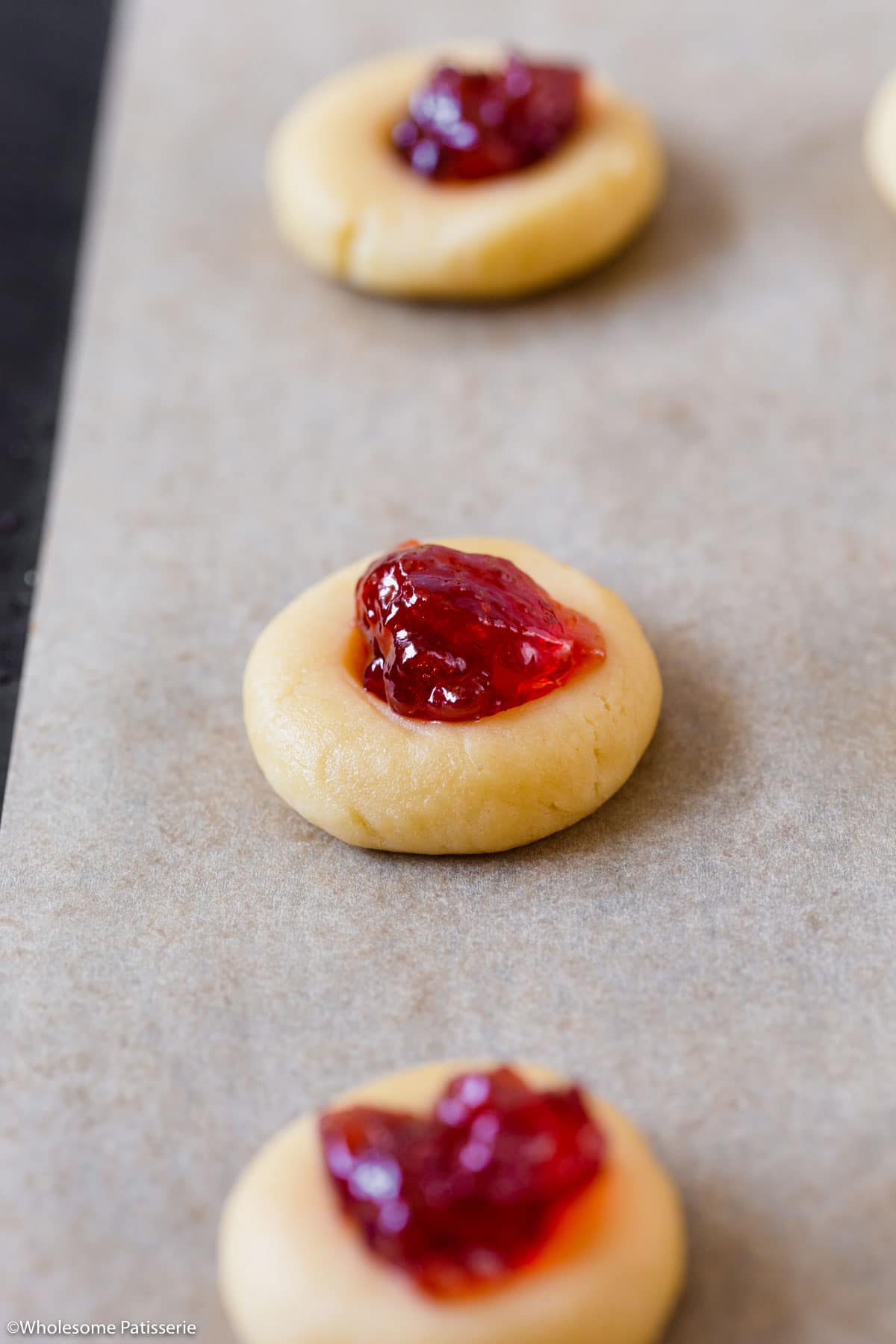 Filling each cookie with the jam