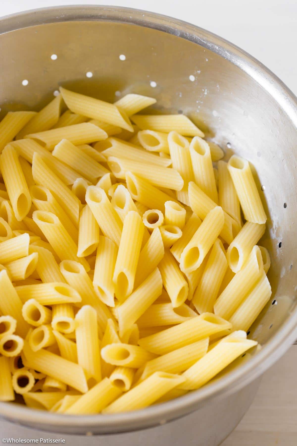 Cooked pasta in colander 
