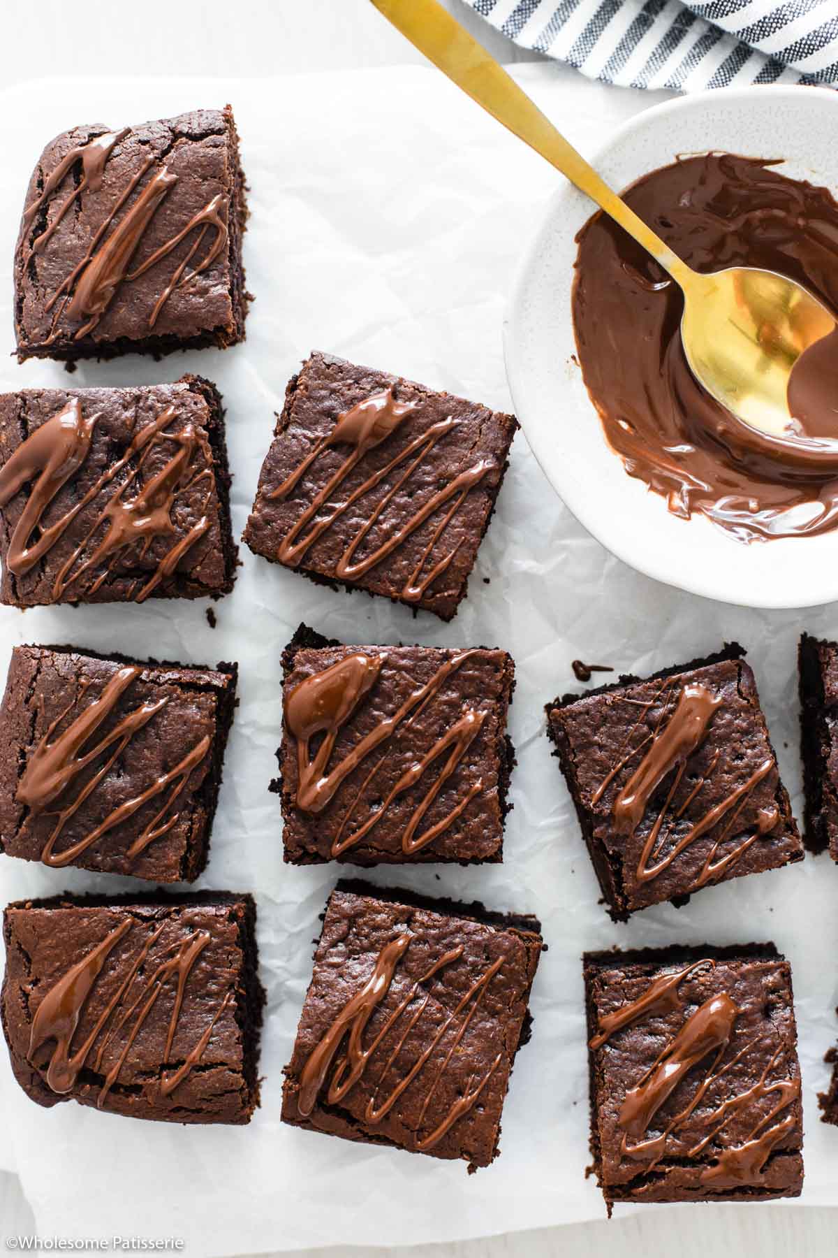 Close up overhead image of baked brownies with the chocolate drizzle to serve