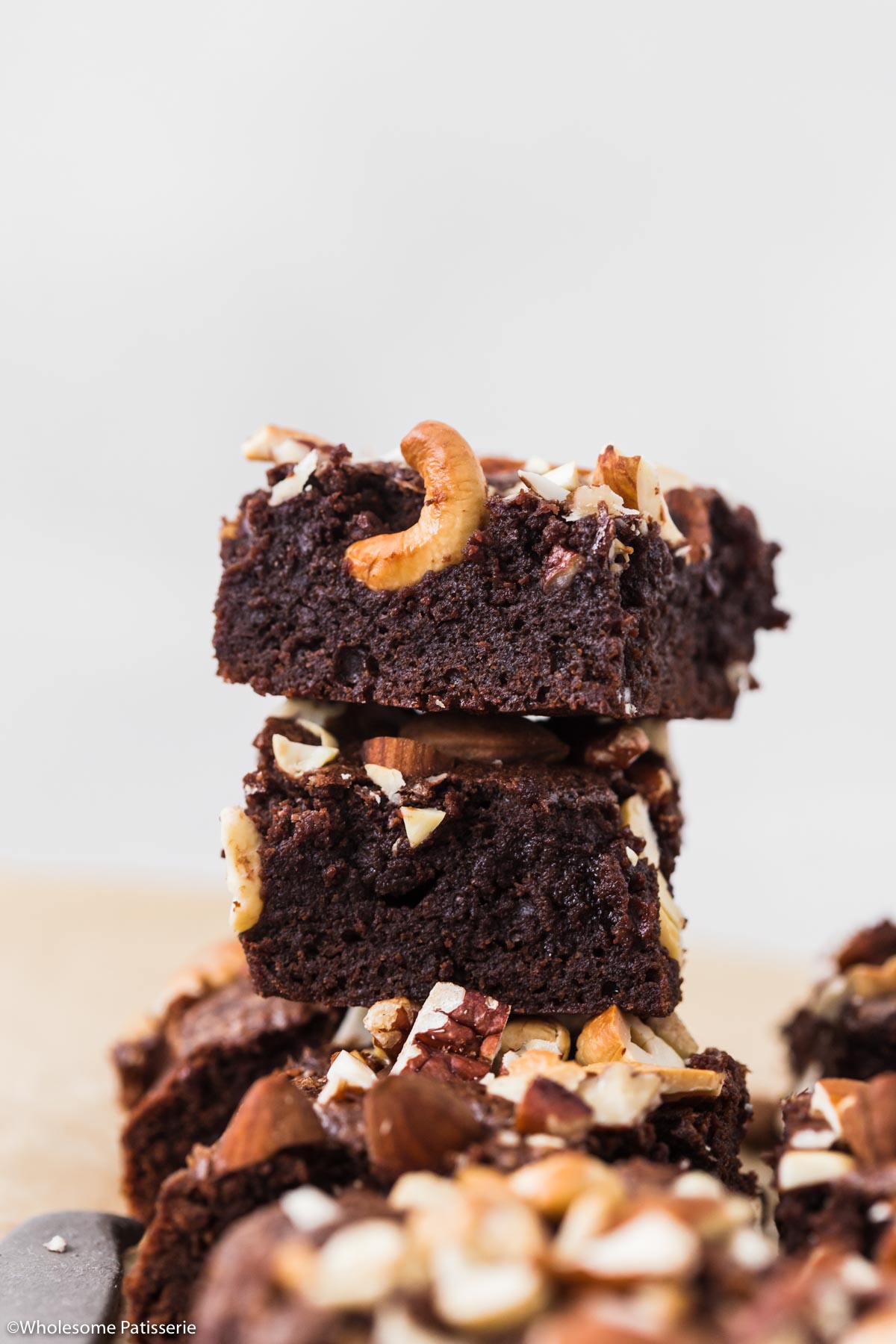 Close up shot of a brownie slice showing the fudgy texture and nuts on top