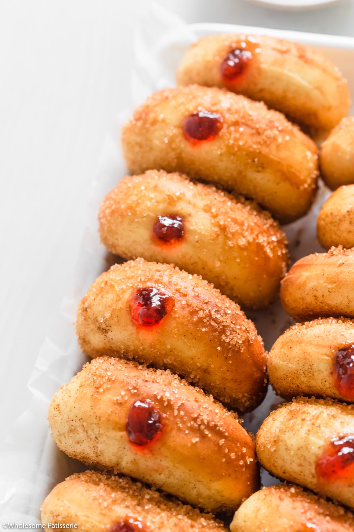 Filling each doughnut with the jam.