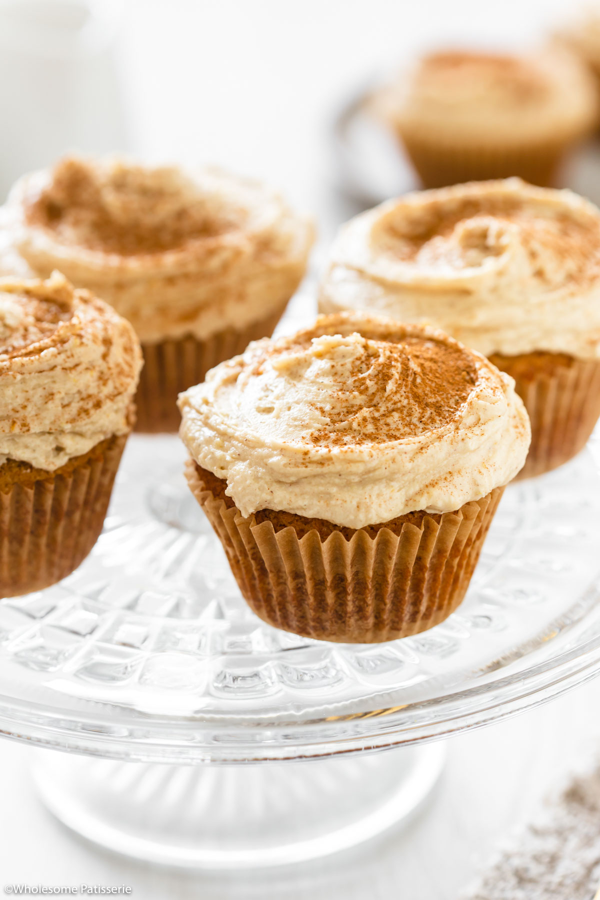 The cupcakes frosted and dusted with cinnamon.