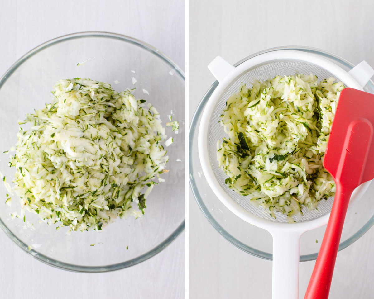 Grated zucchini in a mixing bowl and then in a sieve pushing out the liquid.