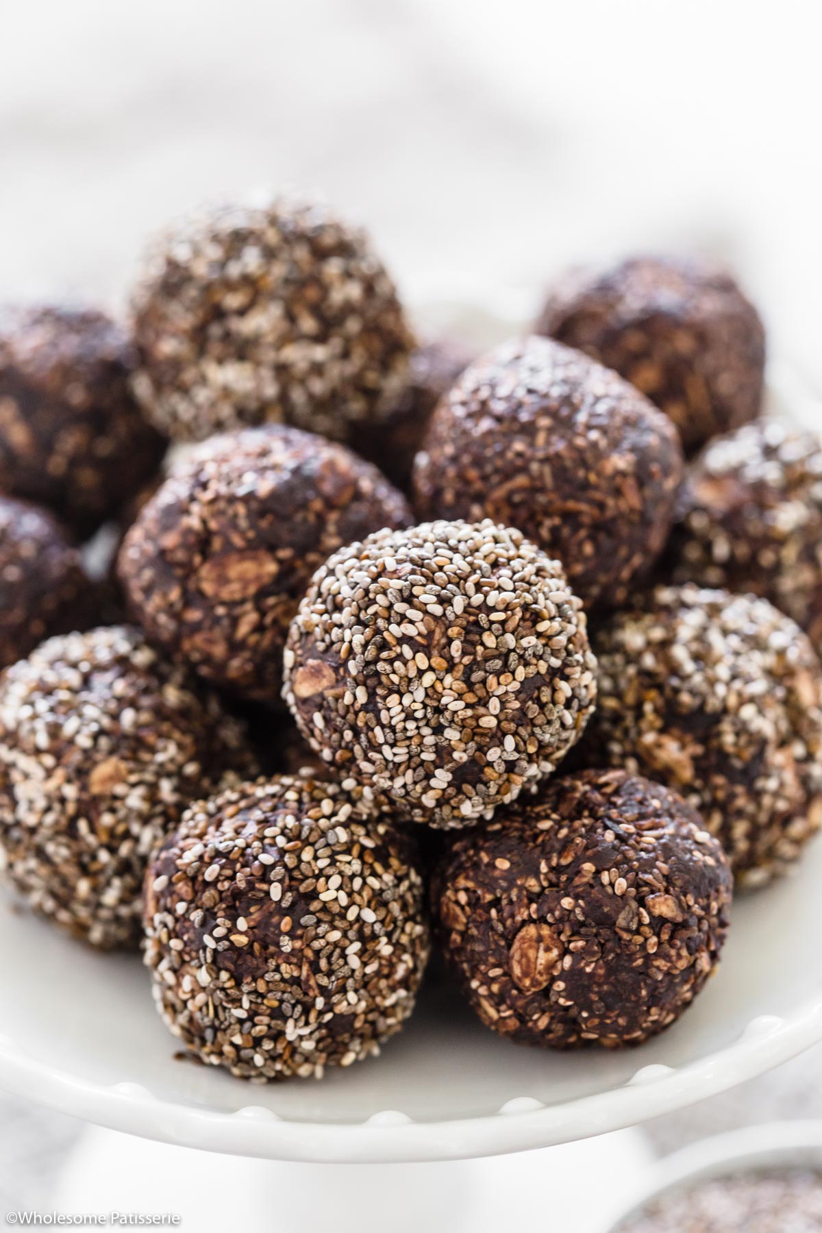 Bliss balls sitting on top of each other.