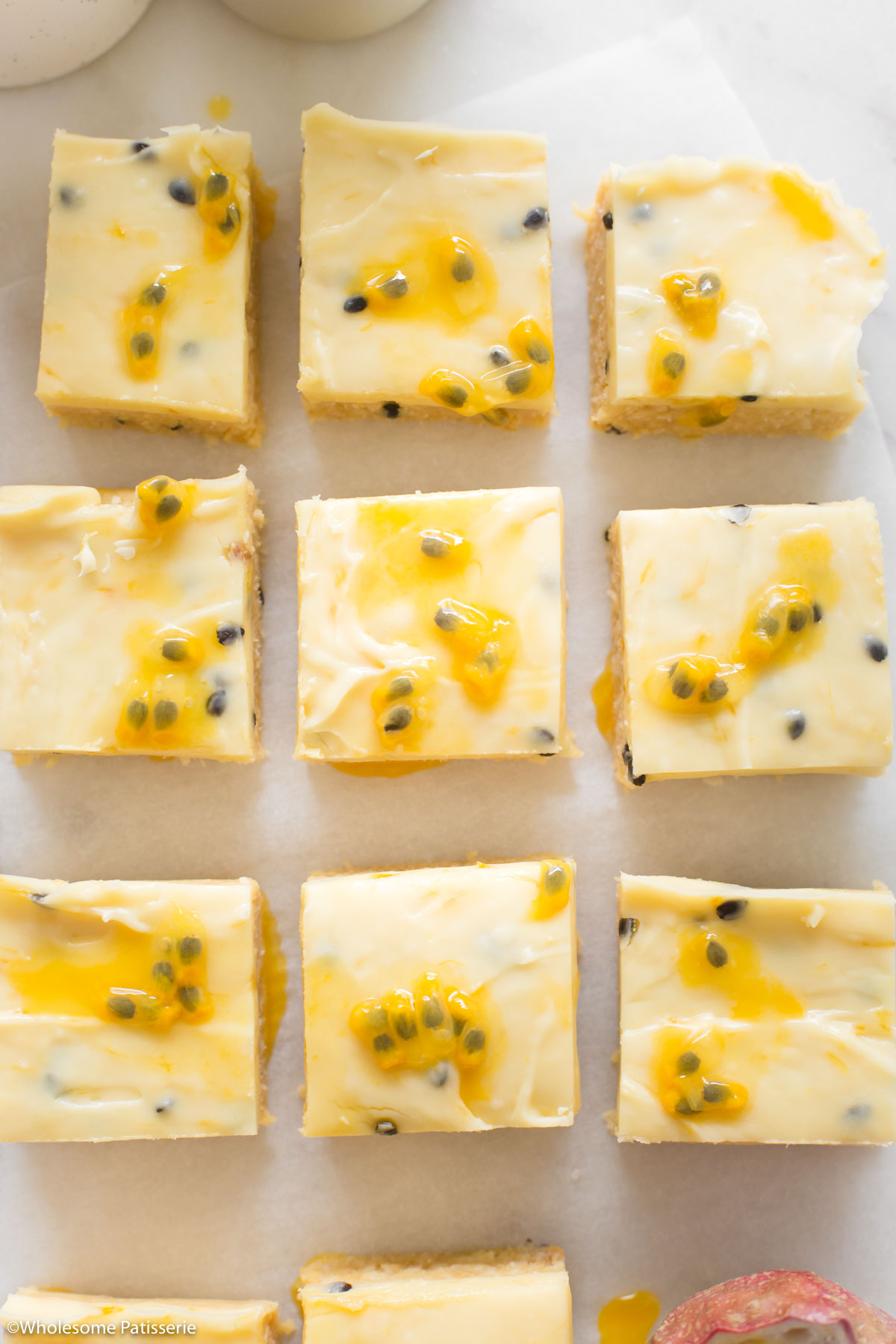 Overhead shot of the passionfruit slices decorated with fresh passionfruit pulp.