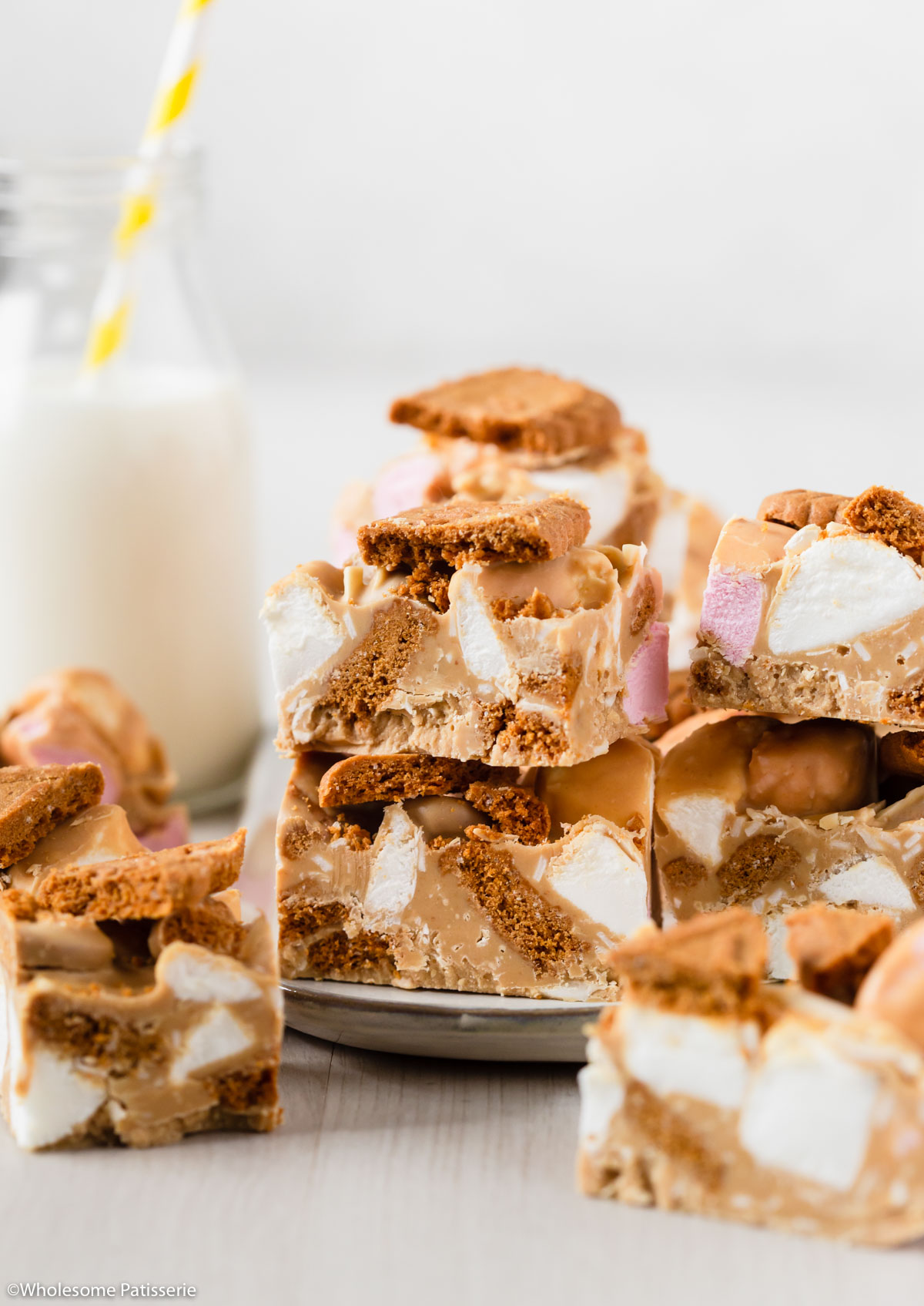 Biscoff rocky road cut into squares and stacked on top of each other to form a tower.