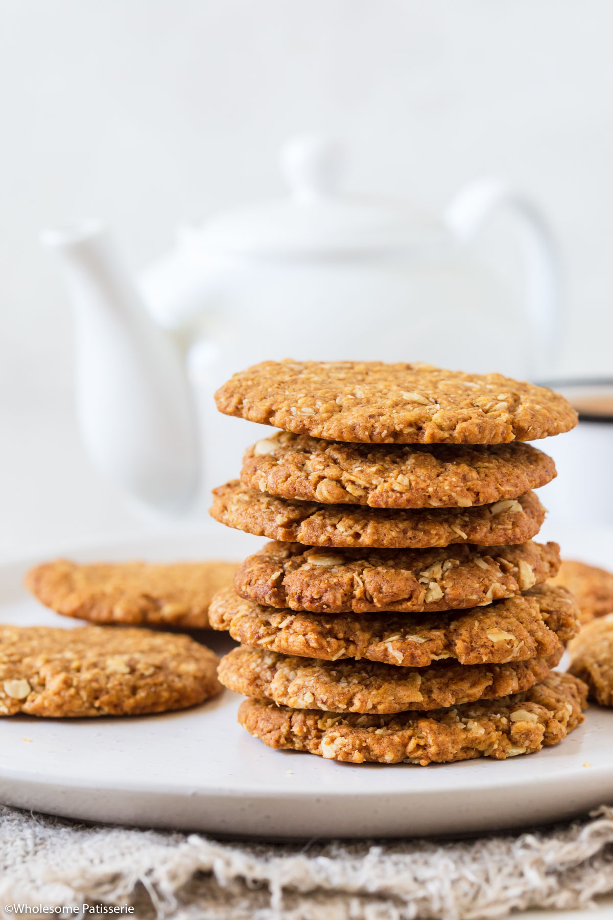 Healthy Anzac biscuits stacked on top of each other.