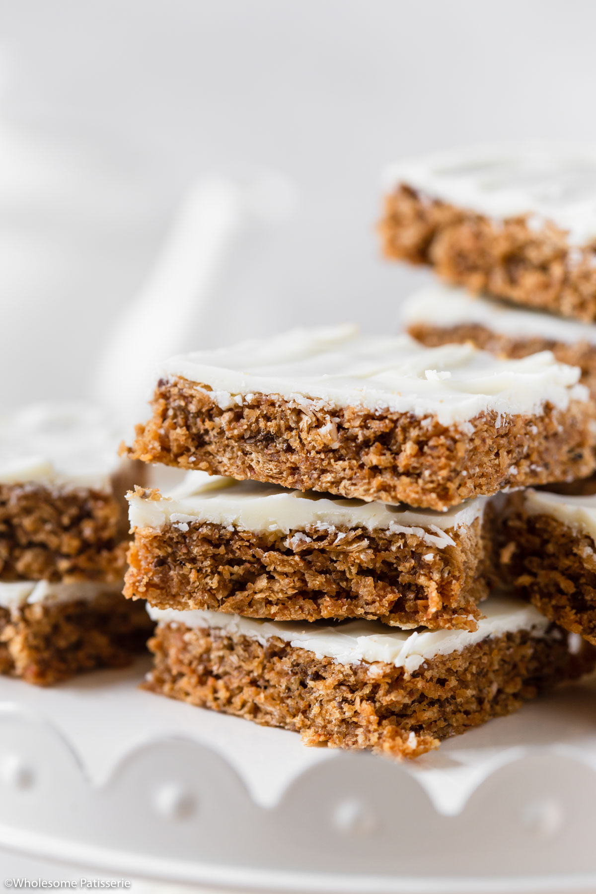 Close-up of No Bake Weetbix slice cut into squares and stacked together on a display stand.
