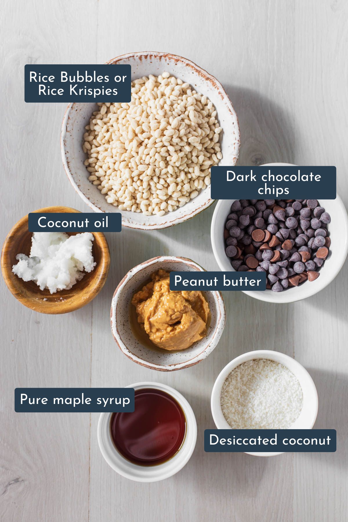 Ingredients to make peanut butter crunch bars are peanut butter, pure maple syrup, coconut oil, desiccated coconut, rice bubbles or rice krispies and dark chocolate chips