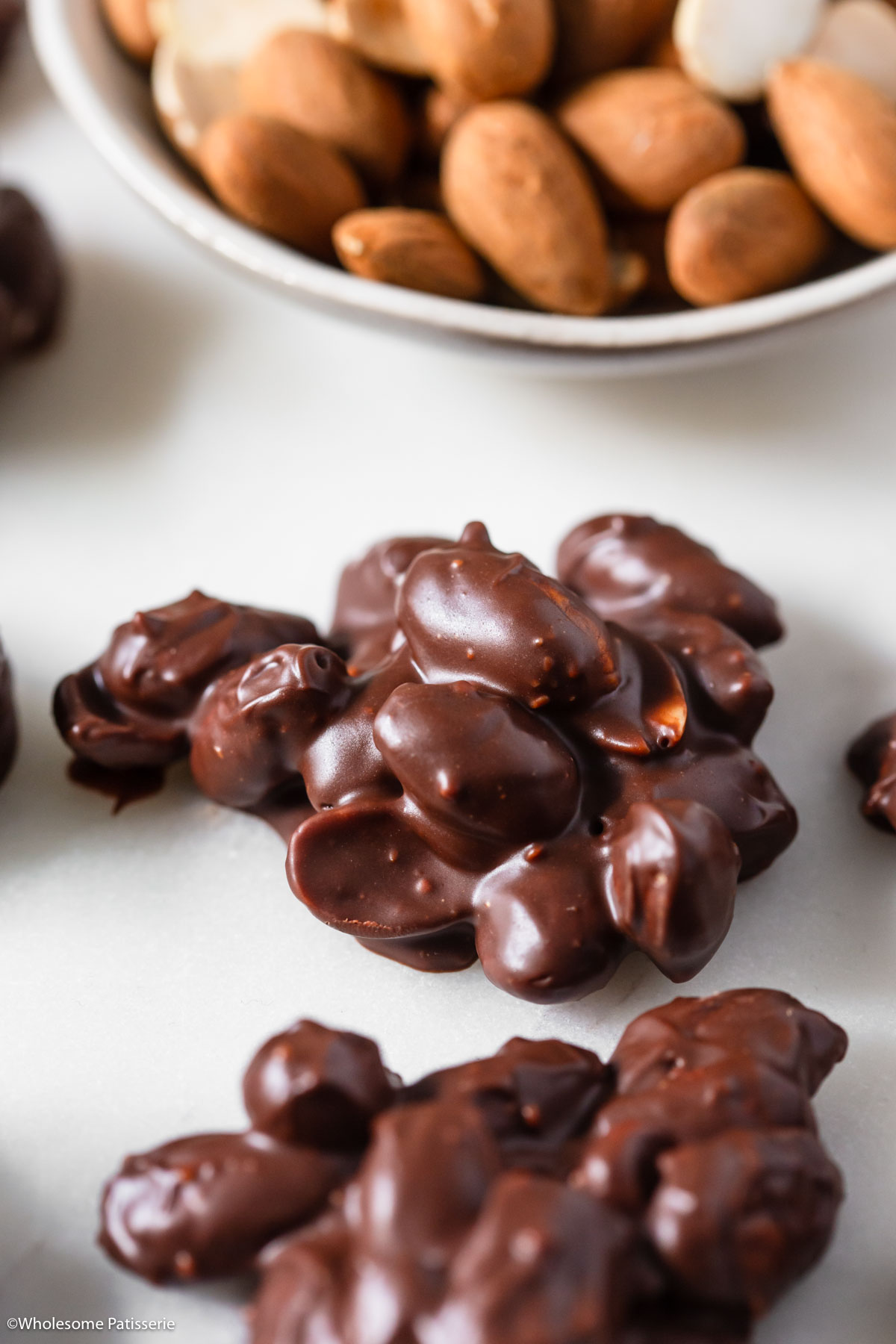 Close up view of one cluster of chocolate covered almonds