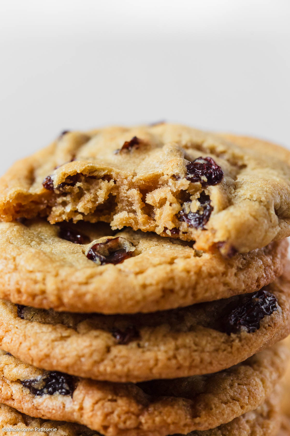 Bite taken out of one cookie thats sitting on stop of others in the tower