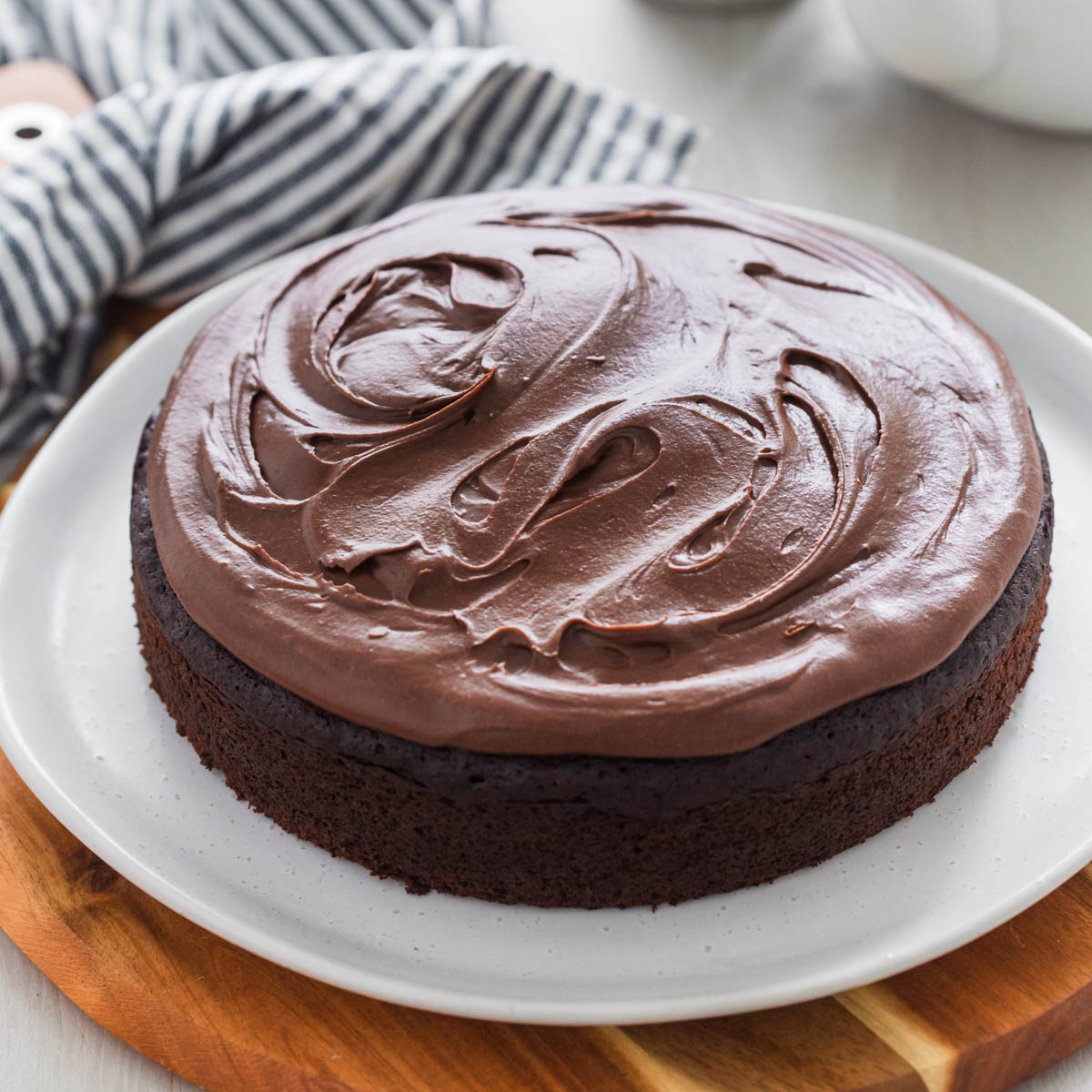 Easy chocolate fudge cake on plate frosted with fudge frosting