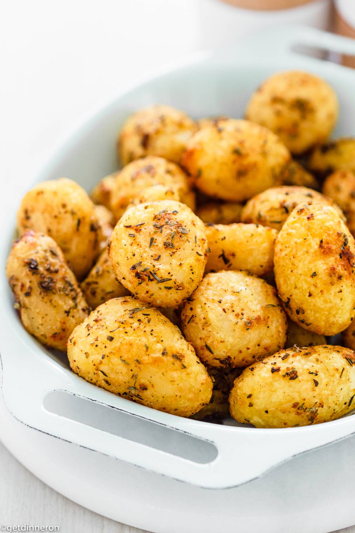 Air fryer canned roasted potatoes displayed in dish.