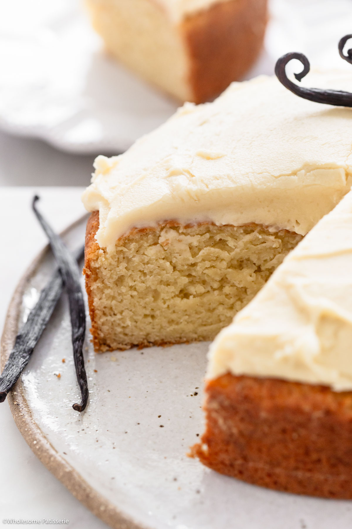 Close up view of eggless vanilla cake sliced to show texture inside