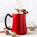 Cinnamon hot chocolate in red mug.
