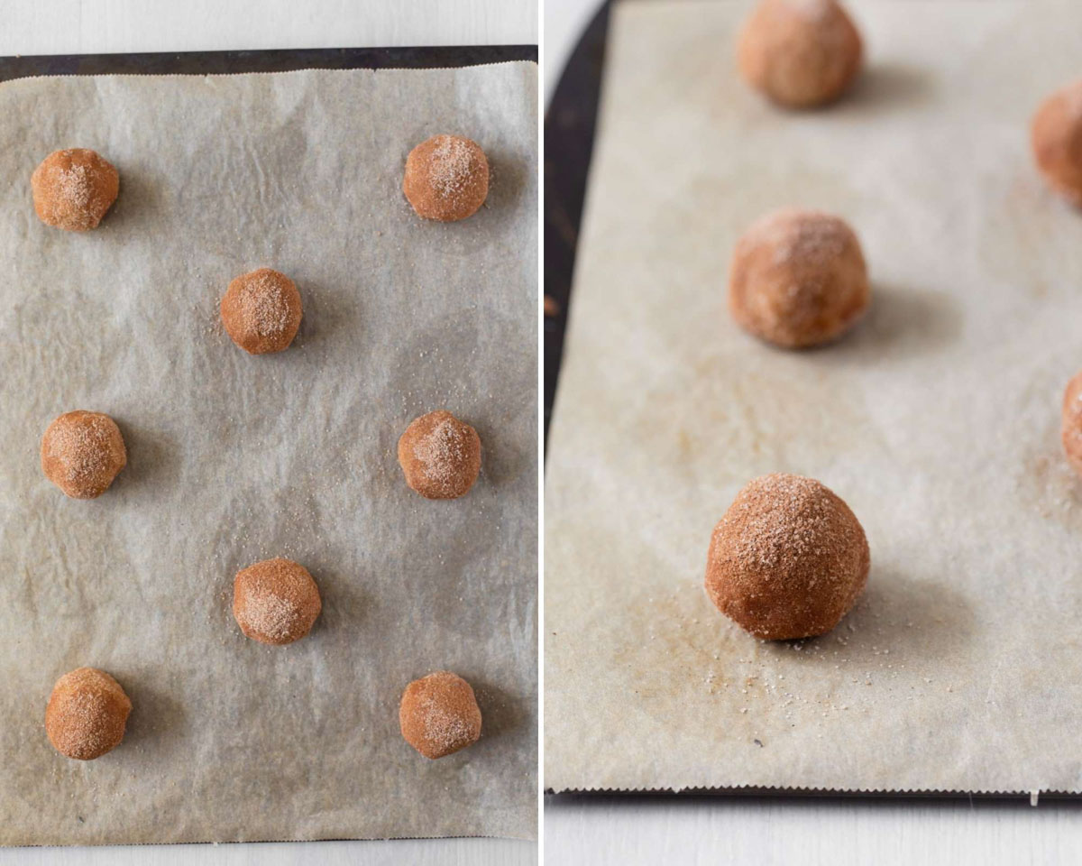Cookie dough balls rolled in cinnamon sugar on parchment lined baking sheet before baking.