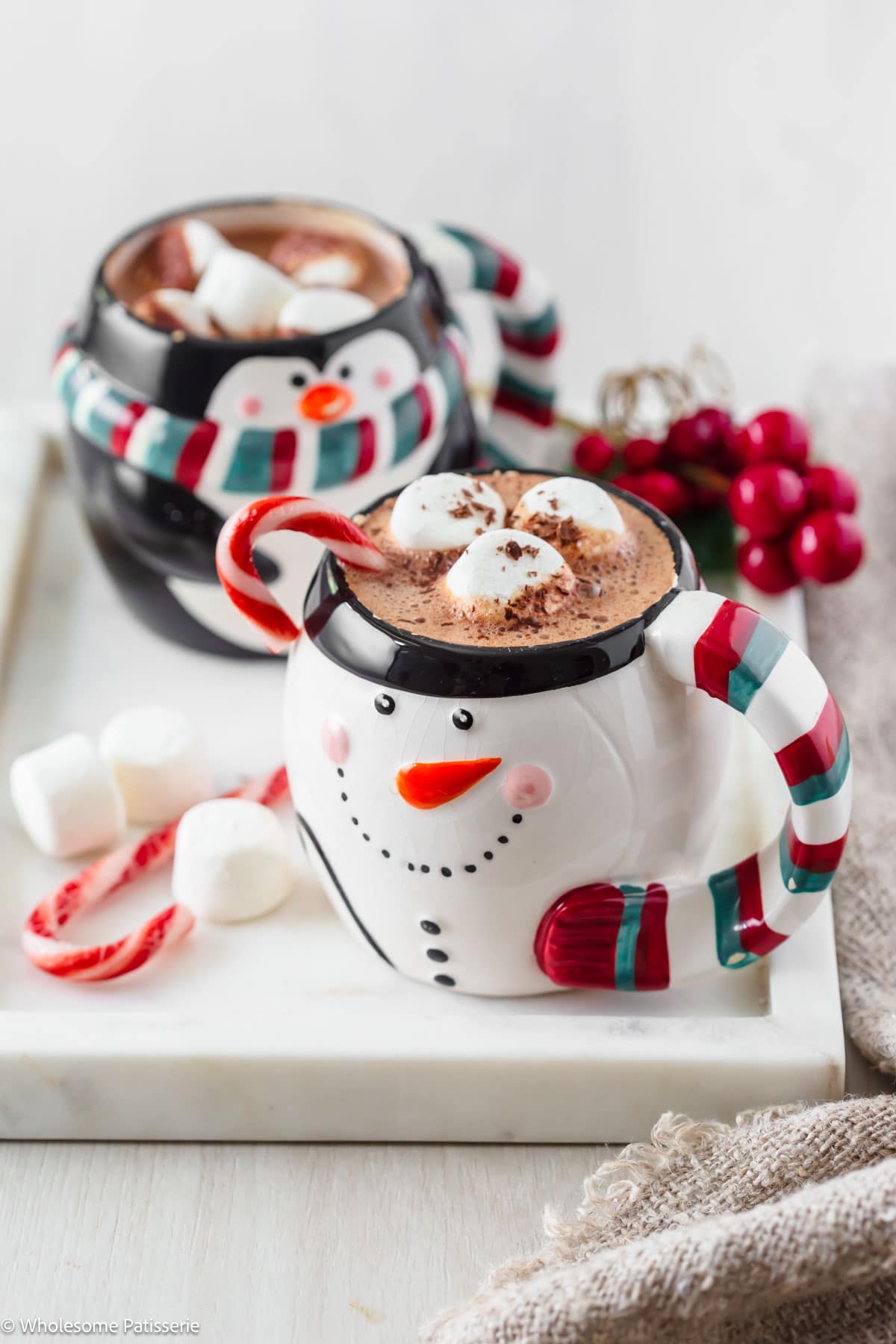 Peppermint hot chocolate in two christmas themed mugs.