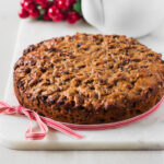 Simple christmas fruit cake on white platter.