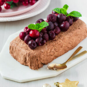 Chocolate semifreddo garnished with frozen cherries and mint leaves.