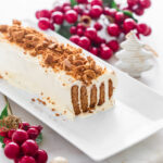 Ripple log on white rectangle platter garnished with crushed gingersnap biscuits.