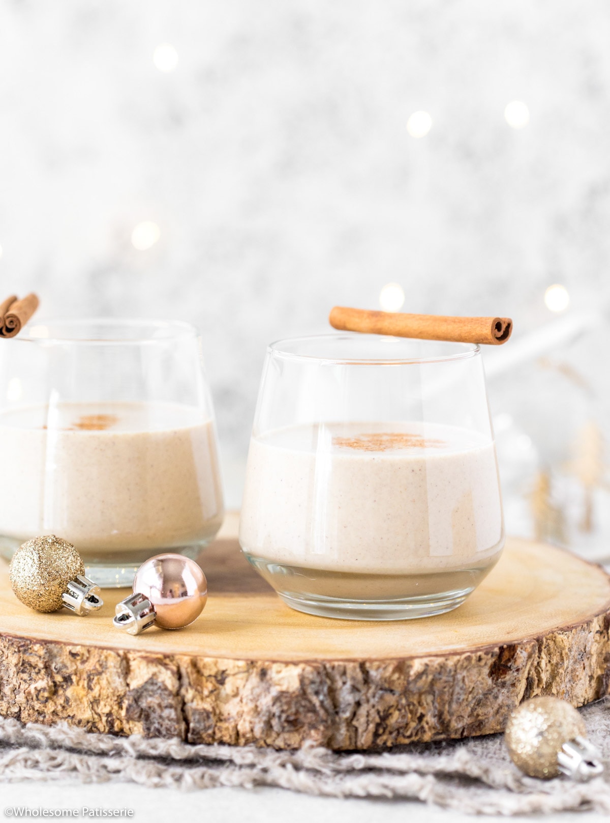 Easy eggnog in serving glasses with cinnamon sticks.