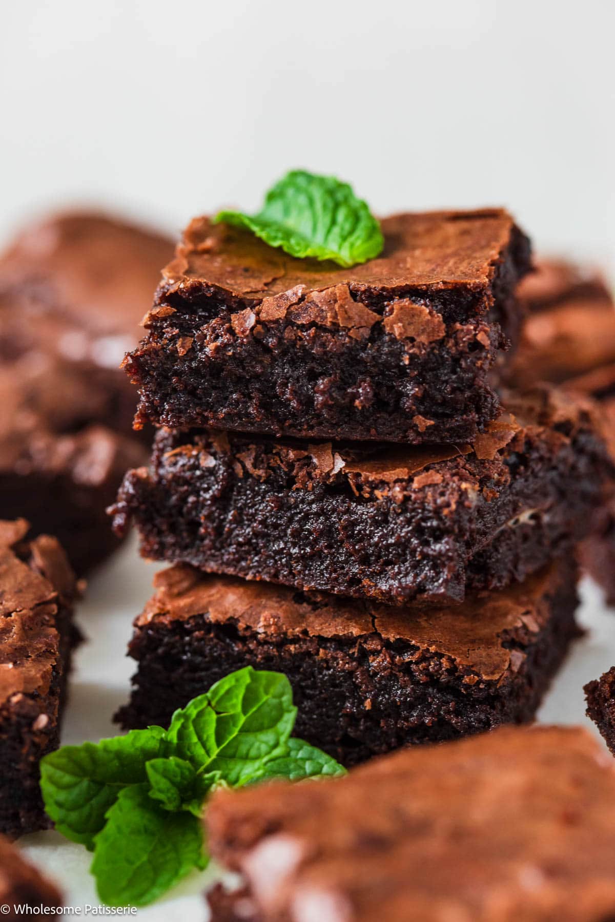 Mint brownies with brownie mix stacked in a tower garnished with fresh mint.