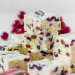 White christmas slice squares stacked on top of each other.