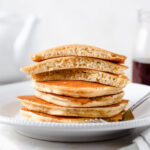 Easy fluffy pancakes in a stack with maple syrup.