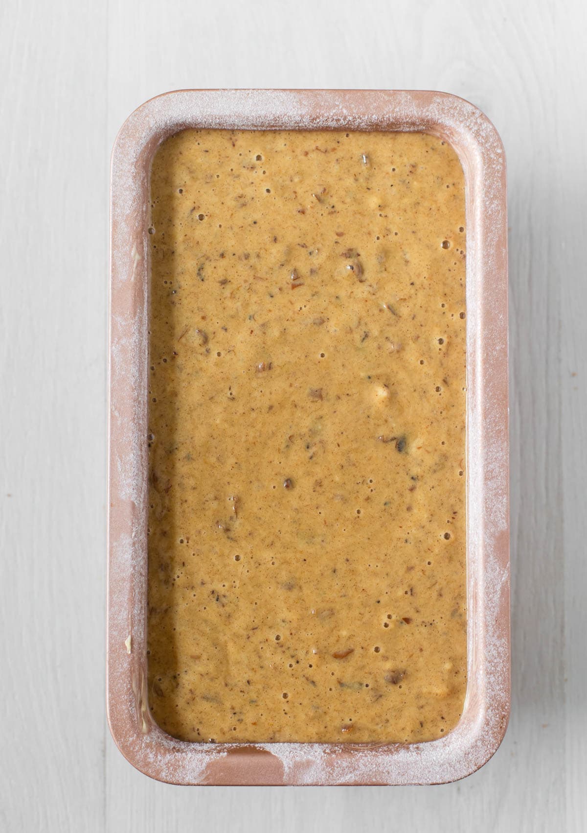 Date loaf batter in greased loaf tin before baking.