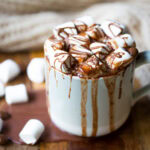 Decadent hot chocolate in mug topped with marshmallows.