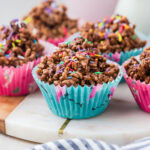 Chocolate crackles in patty cases on board.