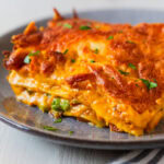 Pumpkin lasagna garnished with parsley.