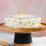 Single layer birthday cake on cake stand.