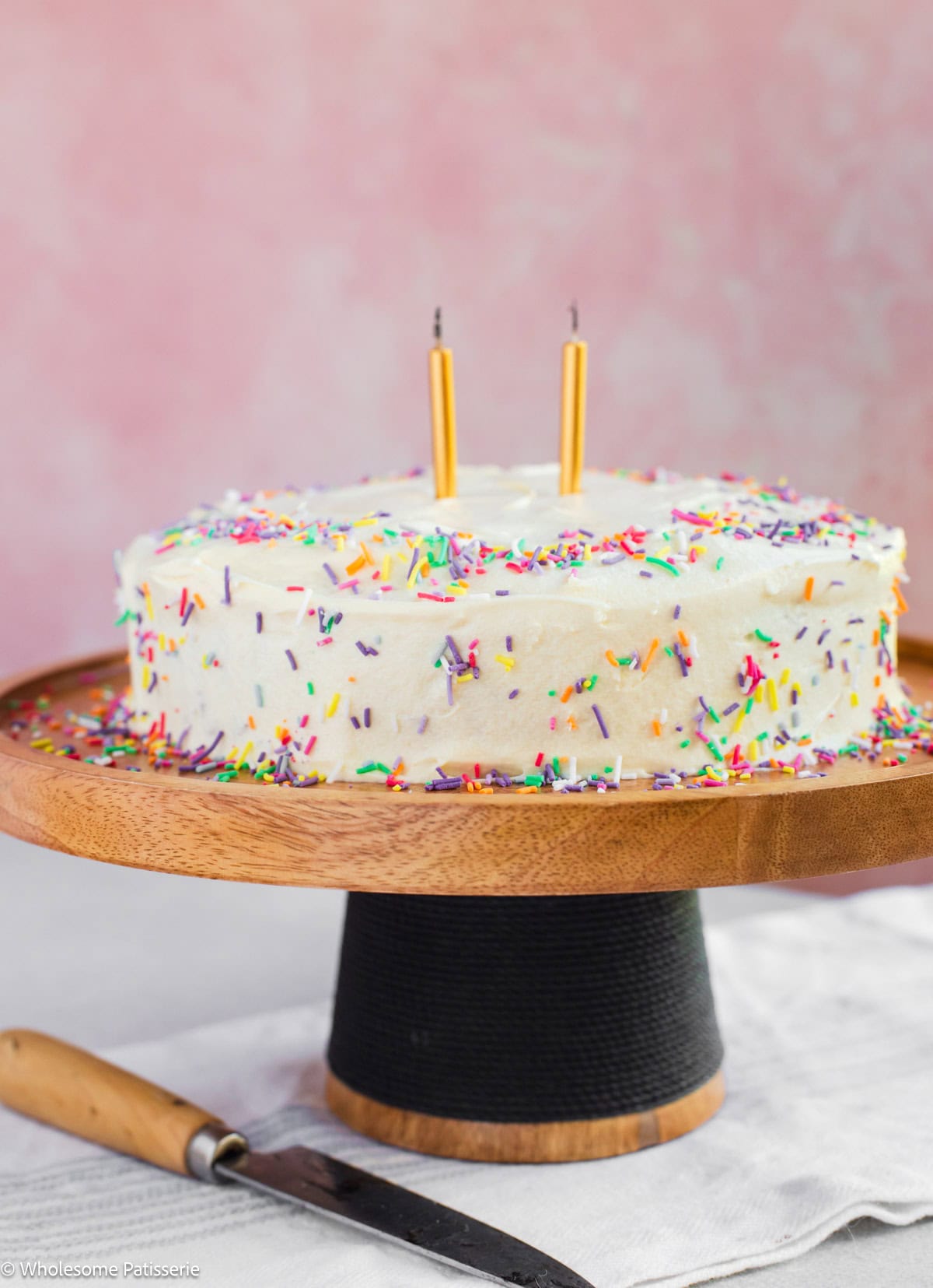 One layer birthday cake on cake stand.