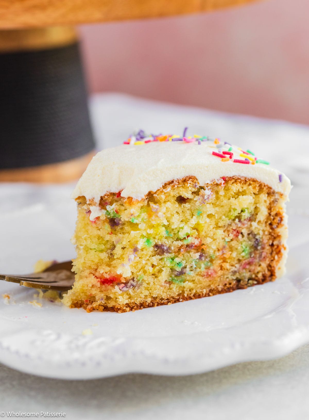 Slice of birthday cake on plate.