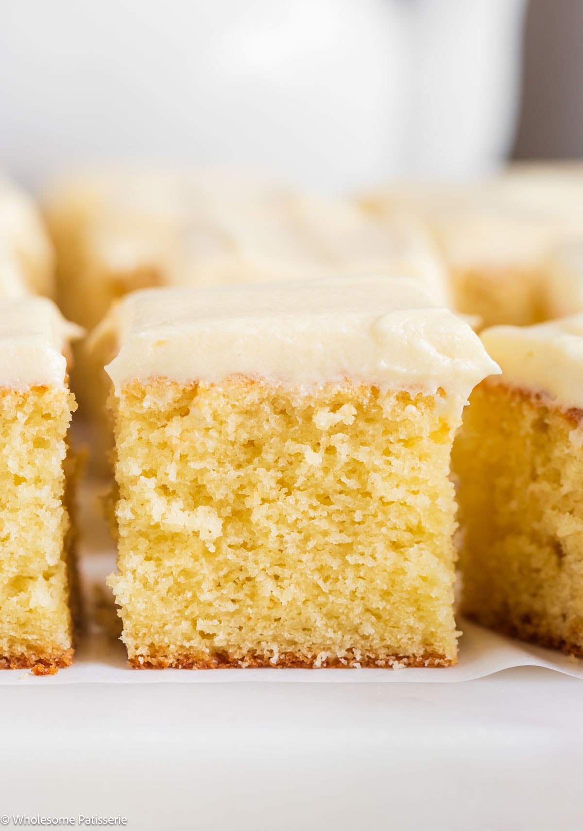 Slice of vanilla cake without vanilla extract with cream cheese frosting.