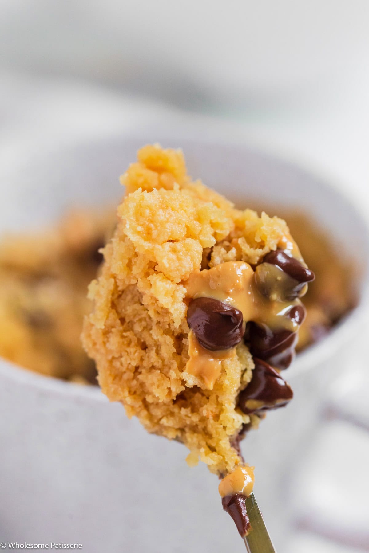 Peanut butter mug cake on spoon after scooping.
